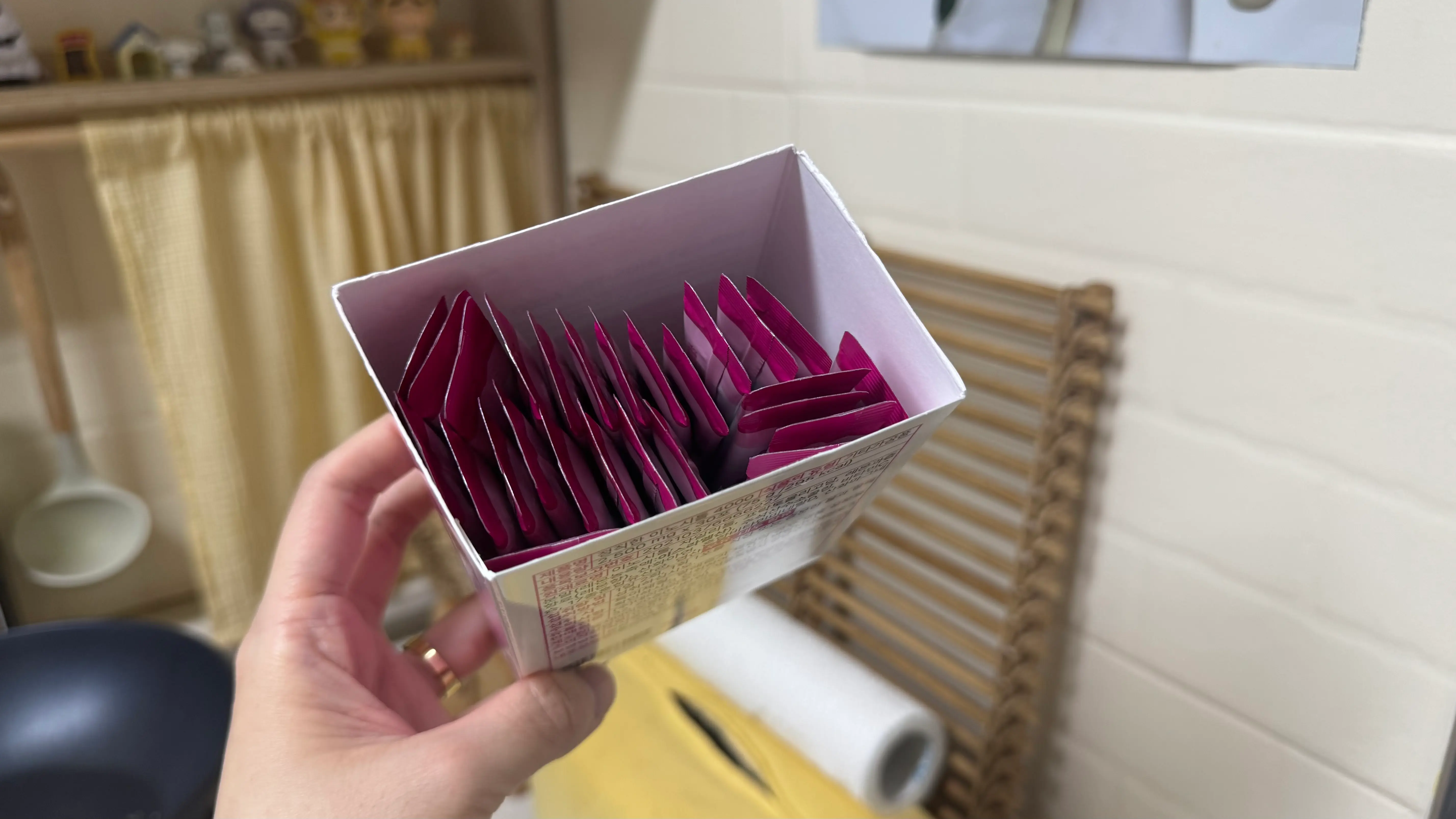 박스 안에 가지런히 담긴 분홍색 스틱형 파우치들이에요.